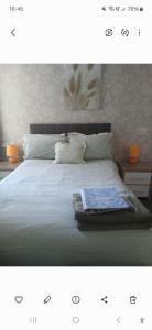 a bed with a blanket and pillows on it at PONDEROSA B&B with free onsite parking and breakfast included in Blackpool