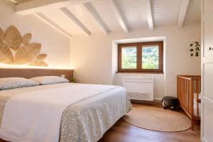 a bedroom with a bed and a window at Casa Cinzia in Gravedona