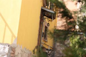 a yellow building with a camera on the side of it at Dimora San Mercurio 100 in Campobasso