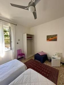 a bedroom with a bed and a ceiling fan at Affittacamere Giulia in Vernazza