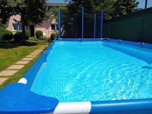 a large swimming pool with blue water in a yard at Rekreacny Dom in Strečno