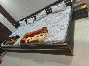 a bed in a room with a bed frame with a sqor at Hotel Vrindavan Near Prem Mandir Distance 15 min in Mathura