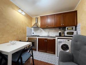 a small kitchen with a white table and a stove top oven at Dimora San Mercurio 100 in Campobasso +55 photos