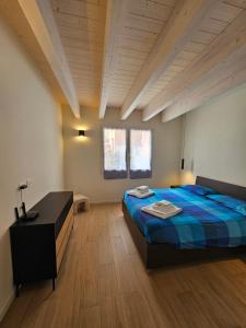 a bedroom with a bed and a desk in it at Case di Daniela in Chiavari
