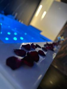 a bunch of roses sitting on top of a table at Moon Luxury Apartment - Jacuzzi & Sauna in Wałbrzych