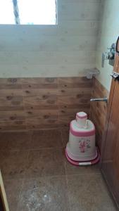 a bathroom with a cake on the floor at VRS Residency in Mysore