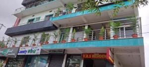 a building with a balcony with plants on it at VRS Residency in Mysore
