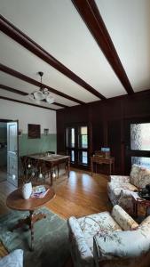 a living room with a couch and a table at Cottage - Kleine alte Villa am See in Bestensee