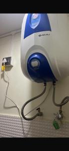 a blow dryer hanging on a wall in a room at Lhamus homestay in Tawang +1 photo