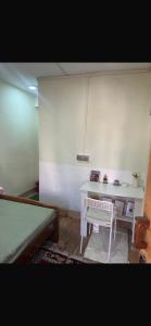 a room with a desk and a bed and a table at Lhamus homestay in Tawang
