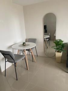 a table and chairs in a room with a mirror at Jbs place at Jtower Residences in Mandaue City