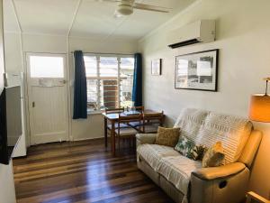 a living room with a couch and a table at Kooyong Apartments, Arcadia in Arcadia
