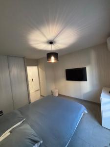 a bedroom with a bed and a ceiling fan at Appartement 2 pièces in Fréjus