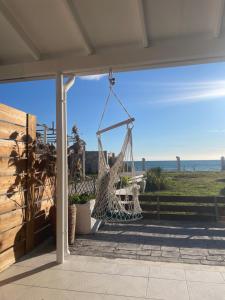 a hammock on a porch with a view of the ocean at Thalassa apartments in Marathias