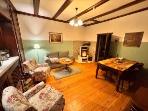 a living room with a couch and a table at Cottage - Kleine alte Villa am See in Bestensee +50 photos