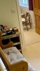 a room with a table and a chair and a stairway at Braemore Walled Garden in Garve