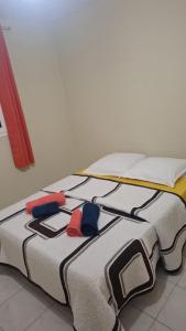 a bed with three hats on top of it at VILLA Ti-COULANGE, Verdoyante in Rivière-Pilote