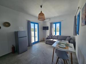 a living room with a couch and a table at Parian Nissos Harmony Living in Angairiá