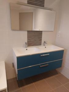 a bathroom with a blue sink and a mirror at Maison à ROSCOFF avec vue mer in Roscoff +28 photos