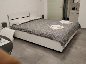 a large bed with two towels on top of it at Lorber house Štinjan - Studio in Pula