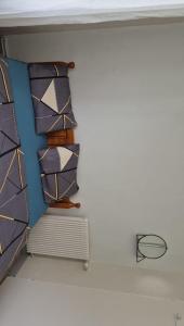 a room with two beds and a shelf with ties at Mais pour ce jour in Brest