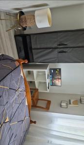 a bedroom with a bed and a desk and a lamp at Mais pour ce jour in Brest