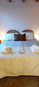a large white bed with two towels on it at TuksandDutsMeppel in Meppel