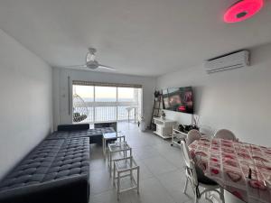 a living room with a couch and a table and a television at Manhattan apartment in Empuriabrava +32 photos