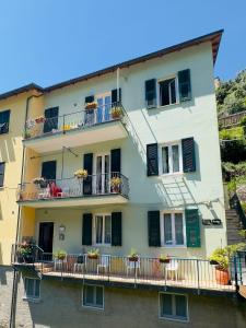 a building with balconies and flowers on it at Affittacamere Giulia in Vernazza