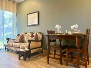 a living room with a couch and a table at Makiti Retreat in Polokwane
