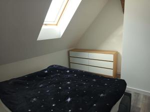 a small bedroom with a bed and a skylight at Miła Przystań in Debrzno