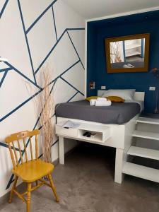 a bedroom with a bed with a mirror and a chair at Palazzo delle Logge in Palermo