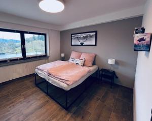 a bedroom with a bed and a window at FeWo Wanderlustig in Wolfstein