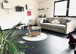 a living room with a couch and a table at FeWo Wanderlustig in Wolfstein +2 photos