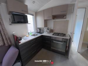 a small kitchen with a sink and a stove at La Carabasse / Mazet 69 in Vias