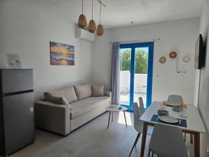 a kitchen and living room with a couch and a table at Parian Nissos Harmony Living in Angairiá
