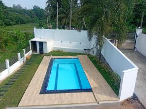 a swimming pool in the backyard of a house at Omik Residence in Dinapamunuwa +7 photos