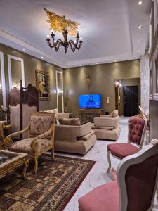 a living room filled with furniture and a chandelier at Galleria 1 in New cairo