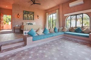 a living room with a blue couch and a bed at Nomada Wellness Hotel in Sayulita +111 photos