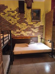 a bedroom with two bunk beds and a brick wall at 1920's Rooms & Beds in Kalamata