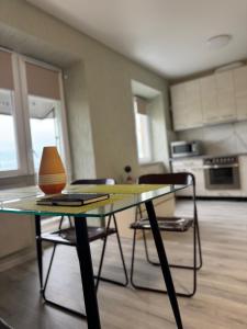 a glass table in a room with a kitchen at Vokzalna in Mukacheve