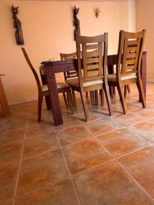 a dining room table and chairs on a tiled floor at Alojamiento casa en Toconao, chile in Toconao