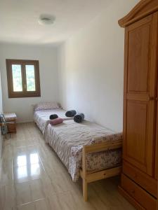 a bedroom with a bed and a dresser at Apartament a Capafonts - "Ribatell" in Capafons