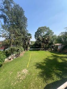 a yard with a yellow line in the grass at CASA NOVA Villa in Noida