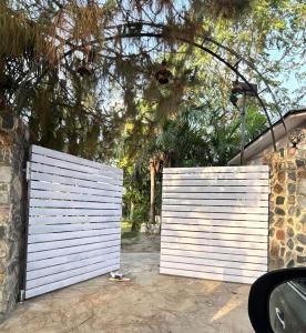 two white gates in front of a house at CASA NOVA Villa in Noida