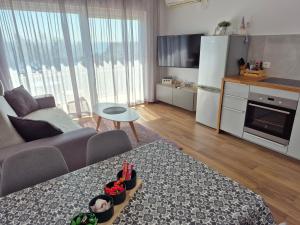 a living room with a couch and a table and a kitchen at Apartman Luka in Novigrad Istria