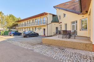 a house with two cars parked in a driveway at Garnet Penzion in Olomouc