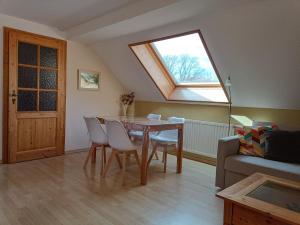 a living room with a table and a window at Forsthaus Stagnieß in Ueckeritz