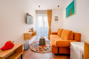 a living room with a couch and a table at Zoe Hotel in Prishtinë