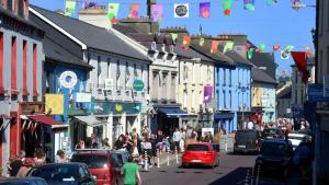 a busy city street with cars and people on the street at Thrush Cottage in Schull